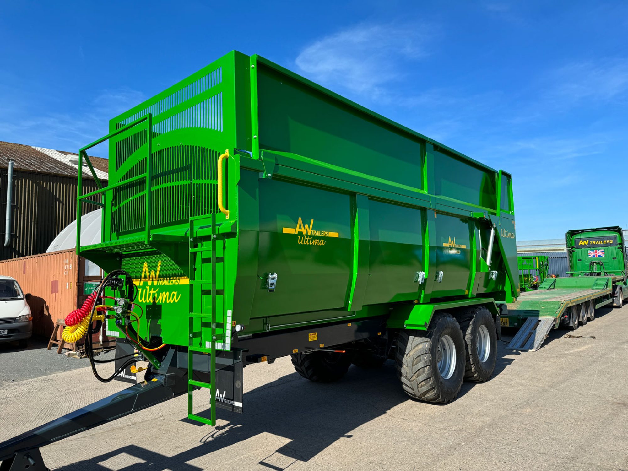 A large green ultima monocoque trailer in a factory carpark