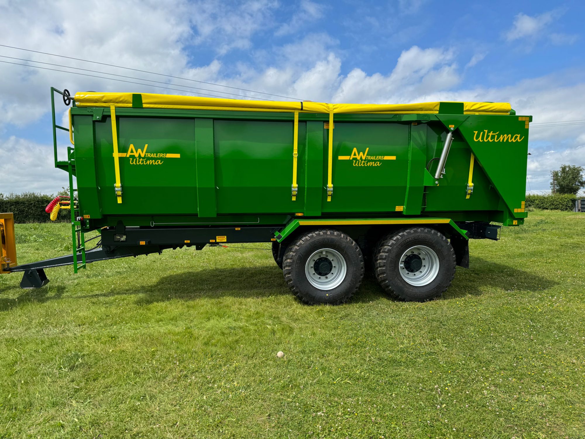 A large green ultima monocoque trailer in a field